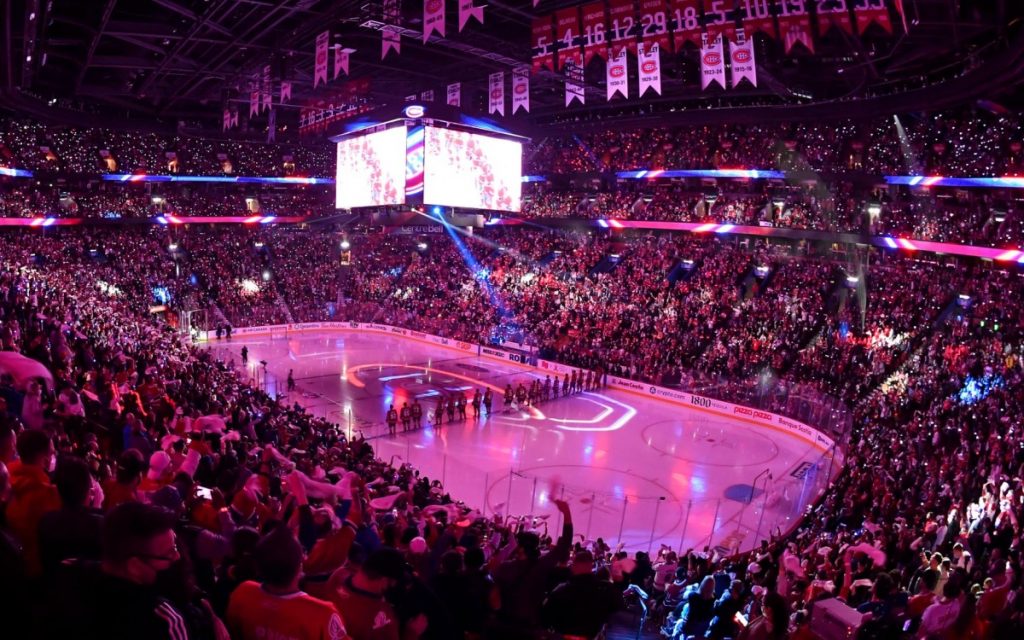 The Bell Centre in Montreal packed with fans before a Canadiens game, lit in red, white, and blue