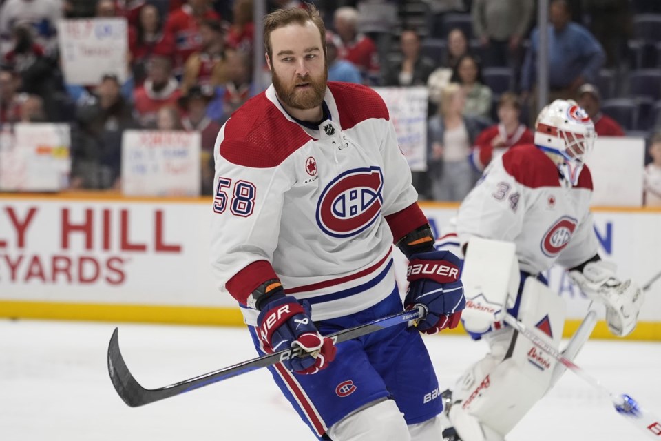 Montreal Canadiens defenseman David Savard skates during warmups in a white away jersey